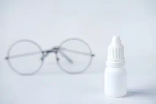 image of an eyeglass with an eye drop