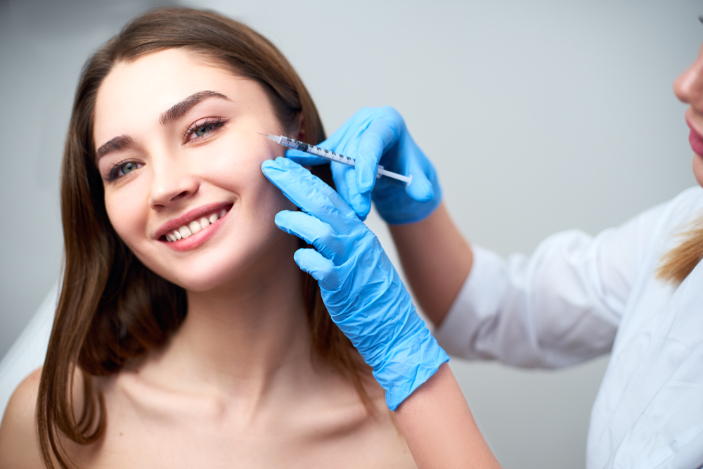 Woman smiling while getting Juvederm injections in her face in Denver, CO