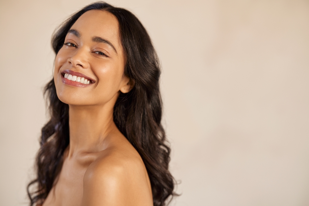 Woman smiling with flawless skin from IPL laser therapy in Denver, CO