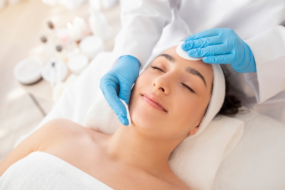 Relaxed woman getting a facial treatment in Denver, CO